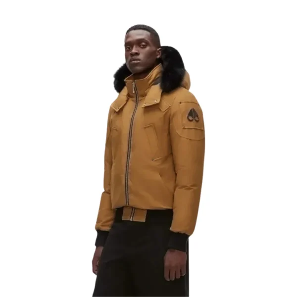 Tan windproof hooded jacket with black fur-lined hood and front pockets